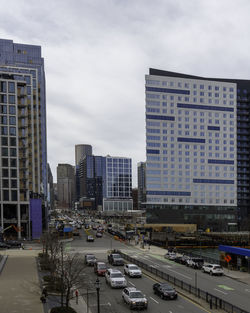 High angle view of traffic on road by buildings against sky