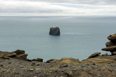 Rocks on sea shore against sky