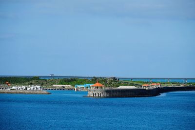 Scenic view of sea and buildings against sky