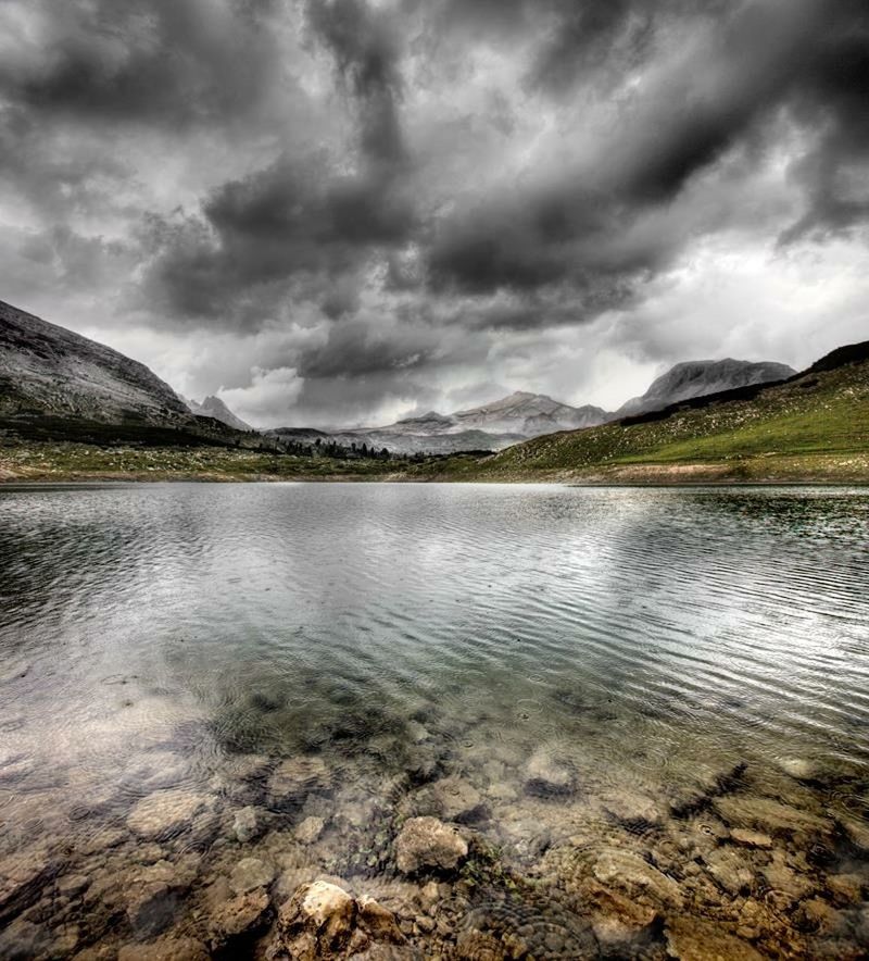 sky, water, cloud - sky, cloudy, tranquil scene, tranquility, scenics, mountain, beauty in nature, lake, overcast, nature, weather, cloud, mountain range, idyllic, storm cloud, reflection, river, non-urban scene