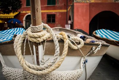 Close-up of rope tied to boat moored at harbor