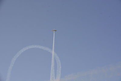 Low angle view of airplane flying against sky