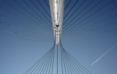 Low angle view of suspension bridge against clear blue sky