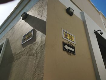 Low angle view of text on wall of building