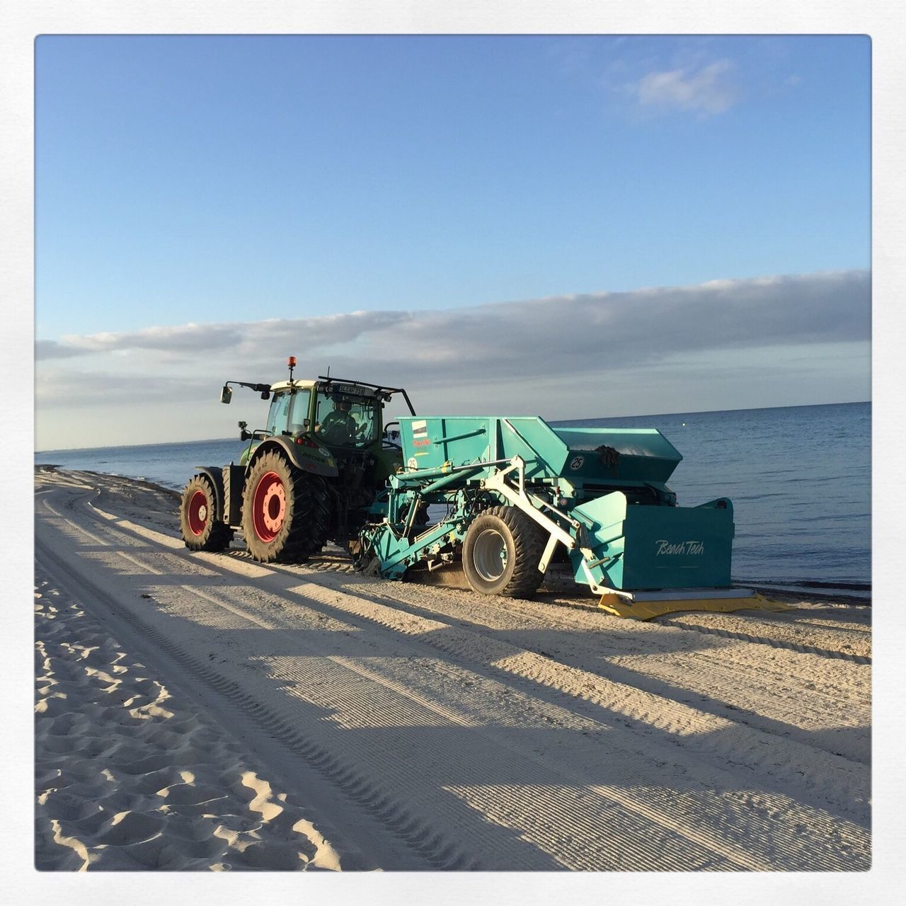 TRACTOR IN SEA AGAINST SKY