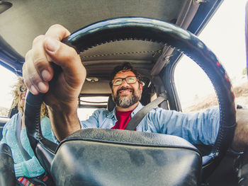 Portrait of man sitting in car