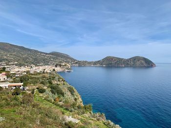 Scenic view of sea by city against sky