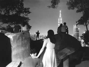 Rear view of women walking in front of building