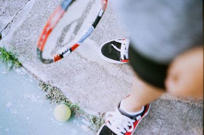 Close-up of person holding tennis racket