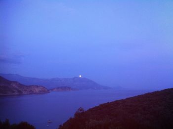 Scenic view of sea against clear blue sky at night