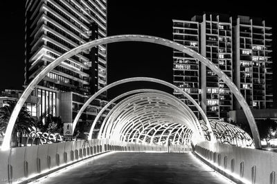 Footbridge in city at night