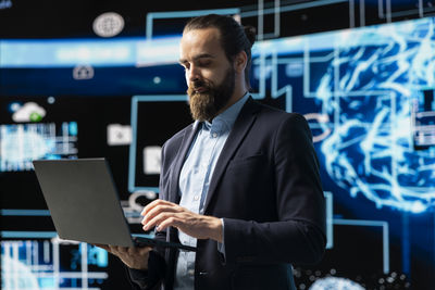 Portrait of businessman using laptop