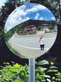 Man standing by plants against sky