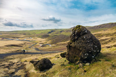 Scenic view of rocks on field against sky