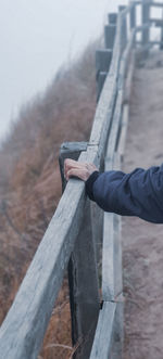 Midsection of person holding umbrella on land