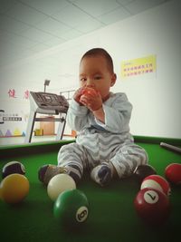 Boy playing with baby sitting on floor