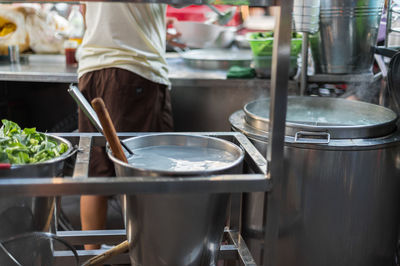 Rear view midsection of man working in kitchen