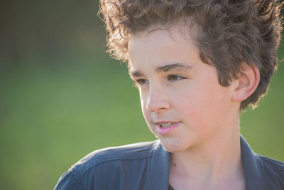 Close-up of boy looking away outdoors