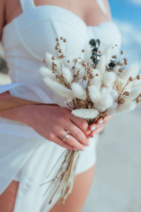 Close-up of a delicate wedding bouquet in the hands of the bride