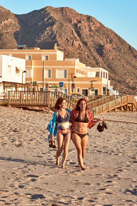 Full length of friends on beach