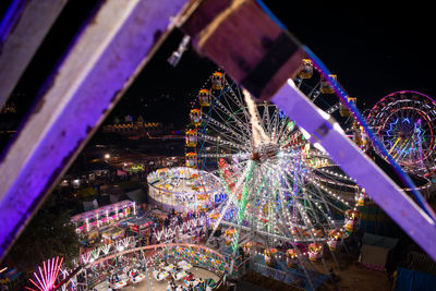 Illuminated ferris wheel at night