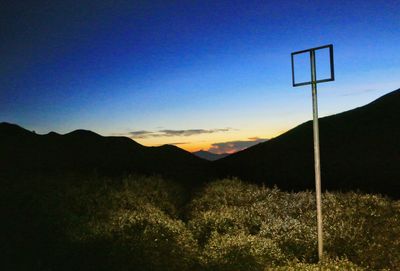 Scenic view of silhouette mountains against clear sky during sunset