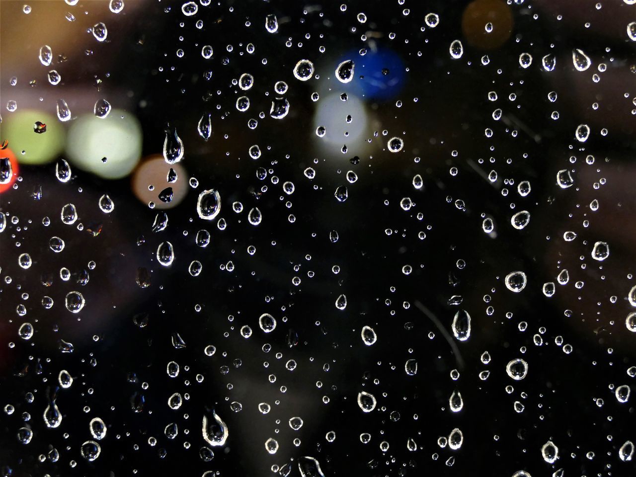 FULL FRAME SHOT OF WET GLASS WITH WATER DROPS