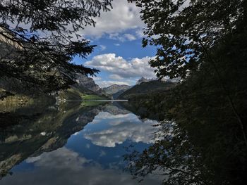 Scenic view of lake and mountains against sky