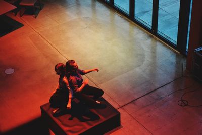 High angle view of woman standing on tiled floor