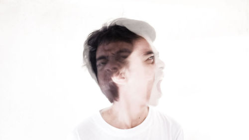 Double exposure of man against white background