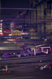 Cars on illuminated city at night