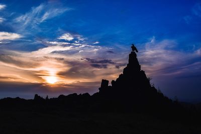 Silhouette of temple against sky during sunset