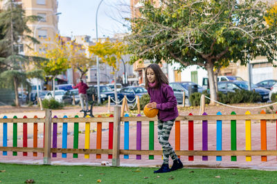 Girl playing with soccer ball in park