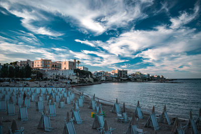 Panoramic view of sea and buildings against sky