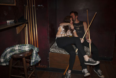 Young couple hanging out at a pool hall