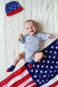 Top view of cute baby lying on usa flag. voting day.