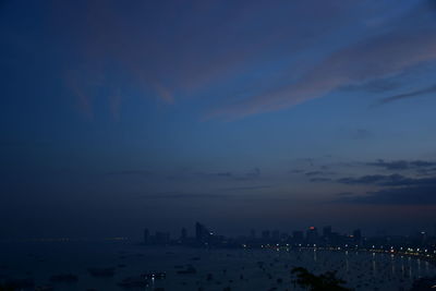 Silhouette buildings against sky at night