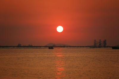 Scenic view of sea against orange sky