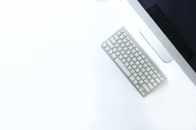 High angle view of laptop on table against white background