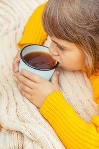 Girl drinking tea at table