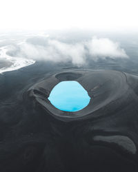 Aerial view of lake amidst mountain