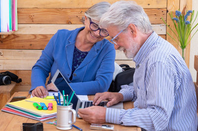 Man and woman using laptop on table