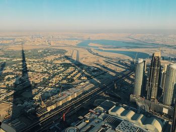 High angle view of city by river against sky