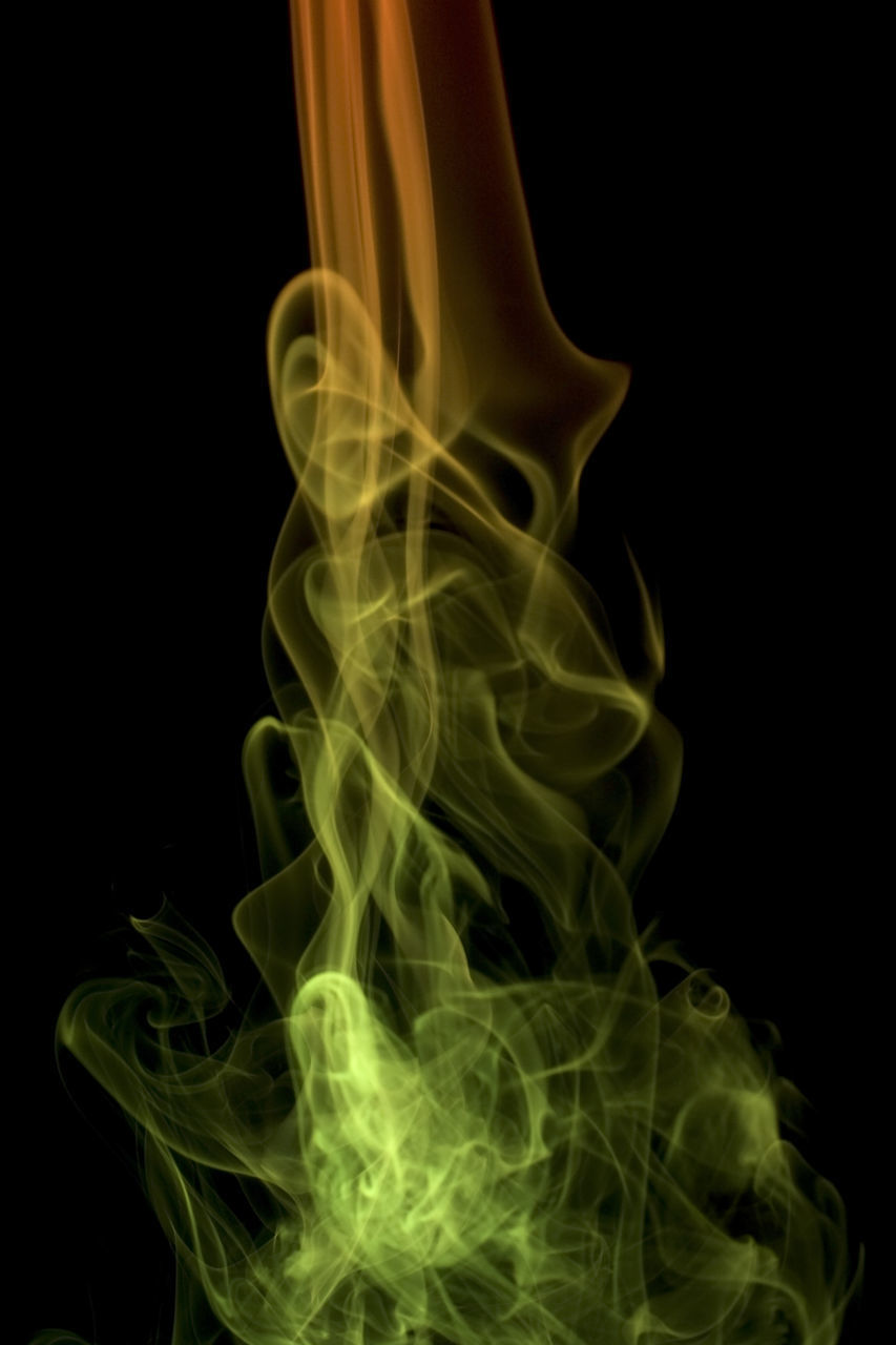 CLOSE-UP OF GREEN LIGHT OVER BLACK BACKGROUND