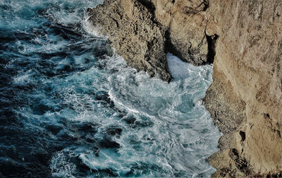 High angle view of water flowing through rocks