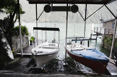 Boats moored on shore against sky