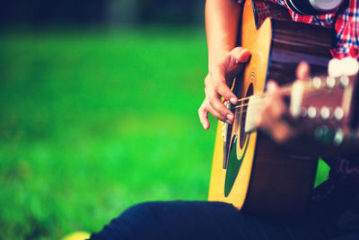 Close-up of man playing guitar outdoors