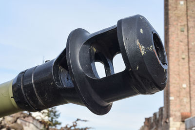 Low angle view of old machinery against sky