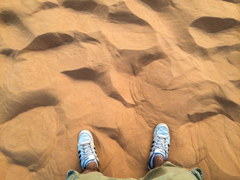 Low section of person standing on tiled floor