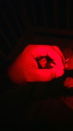 Close-up of red light over black background